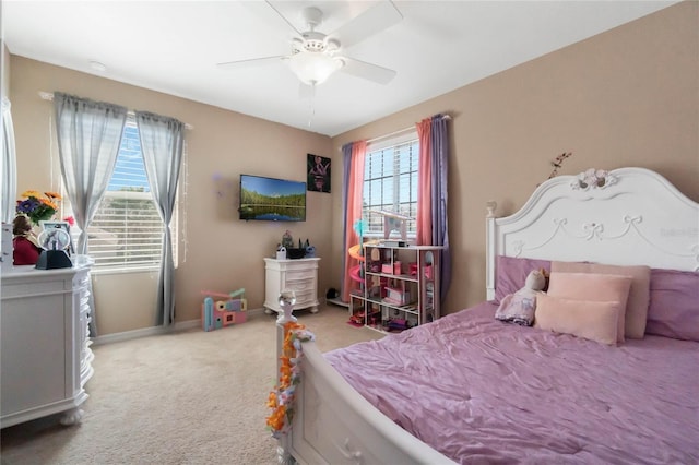 carpeted bedroom featuring baseboards and a ceiling fan