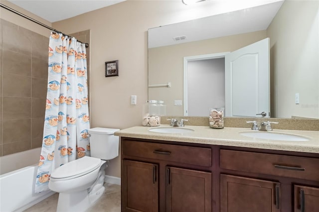 full bathroom with toilet, double vanity, visible vents, and a sink