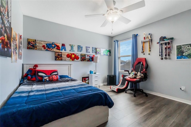 bedroom featuring ceiling fan, baseboards, and wood finished floors