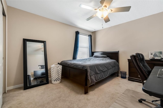 bedroom with light carpet, a ceiling fan, and baseboards