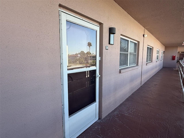 view of exterior entry with stucco siding