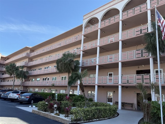 view of building exterior with uncovered parking