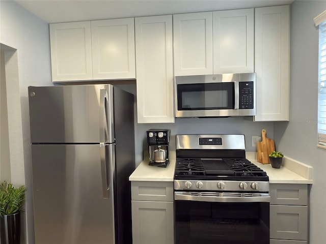 kitchen featuring white cabinetry, light countertops, and appliances with stainless steel finishes