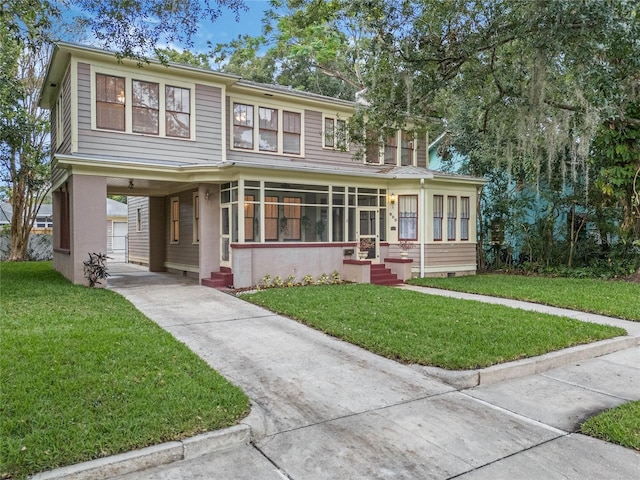 view of front of property with a carport, a front yard, concrete driveway, and stucco siding