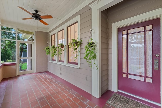 doorway to property with covered porch and a ceiling fan