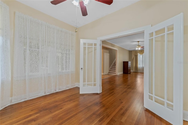 unfurnished room with french doors, stairway, and hardwood / wood-style floors