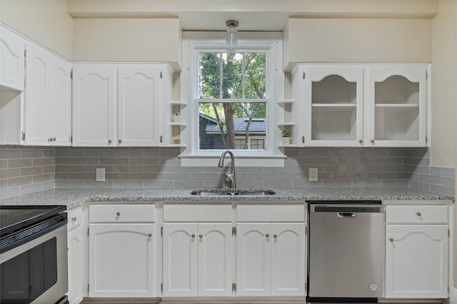 kitchen featuring light stone counters, stainless steel appliances, a sink, white cabinetry, and open shelves