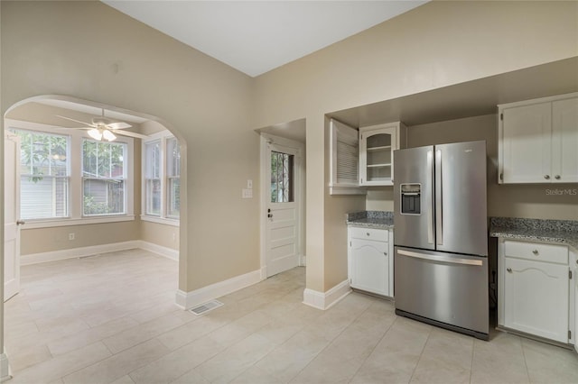 kitchen featuring stainless steel fridge, visible vents, white cabinets, and a ceiling fan