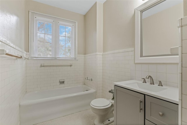 full bath featuring toilet, a bath, tile patterned flooring, vanity, and tile walls