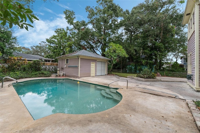 view of pool with a patio, an outdoor structure, a fenced backyard, and a fenced in pool