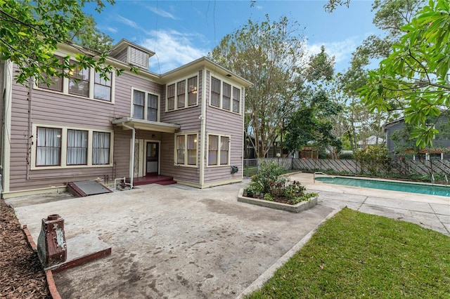 back of house featuring a patio, fence, and a fenced in pool