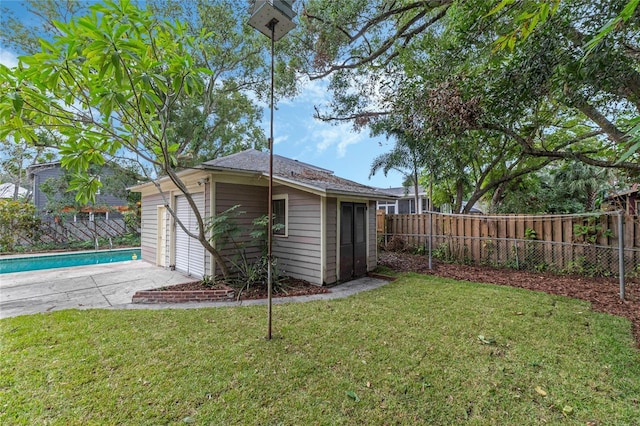 view of outbuilding featuring an outbuilding, a fenced backyard, and a fenced in pool