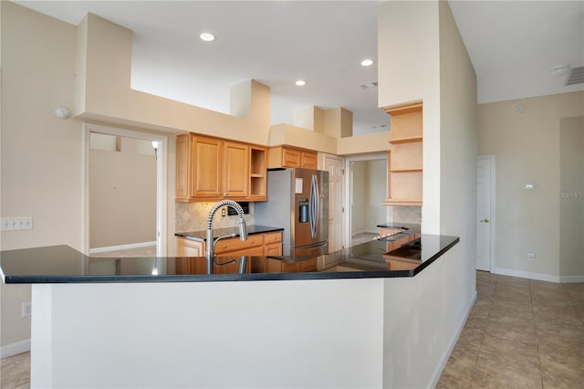 kitchen with decorative backsplash, dark countertops, stainless steel fridge with ice dispenser, and open shelves