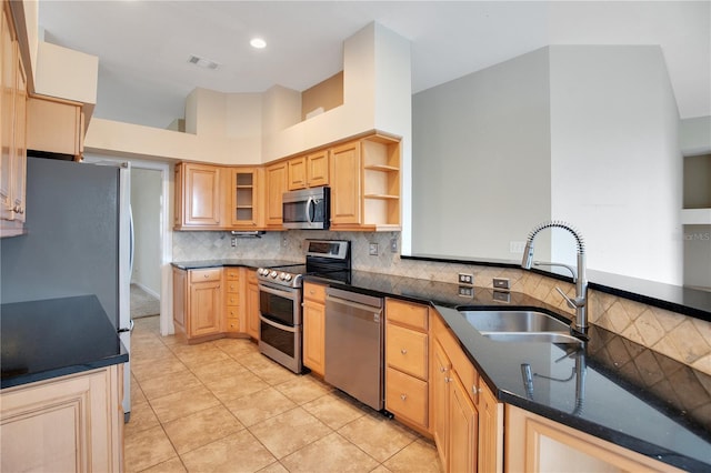 kitchen with light brown cabinets, a sink, appliances with stainless steel finishes, backsplash, and open shelves