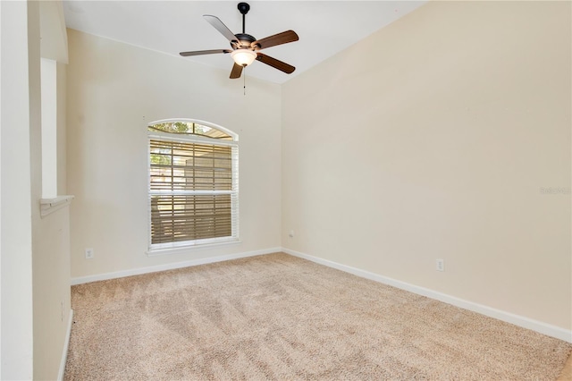 empty room featuring carpet floors, baseboards, and a ceiling fan