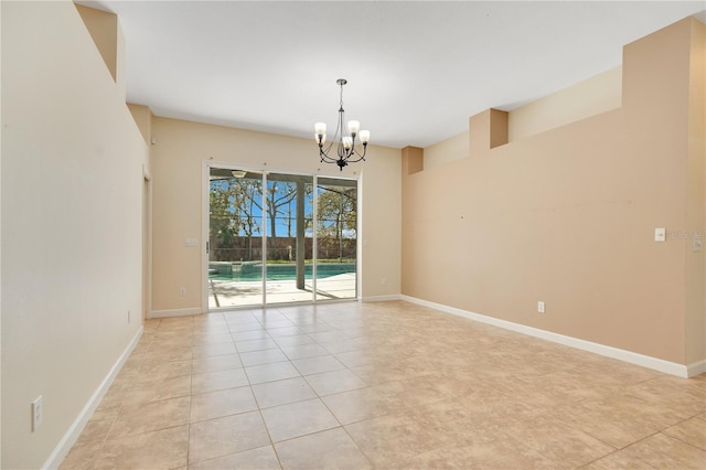 spare room featuring light tile patterned floors, baseboards, and an inviting chandelier