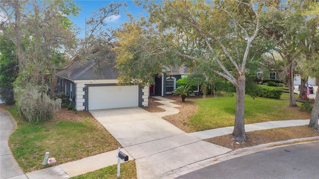 view of property hidden behind natural elements with an attached garage, driveway, a shingled roof, and a front yard