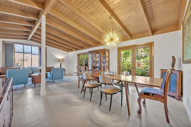 dining area featuring a healthy amount of sunlight, vaulted ceiling with beams, and french doors