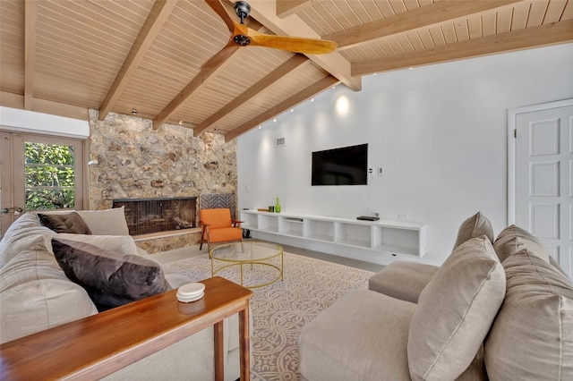 living room with lofted ceiling with beams, a fireplace, and wooden ceiling