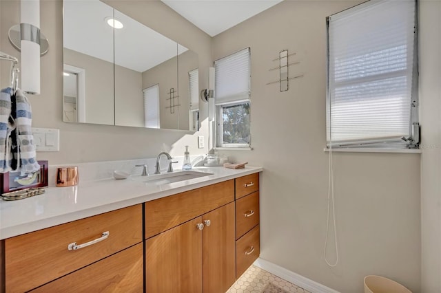 bathroom featuring baseboards and vanity