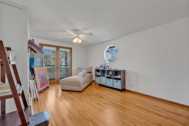 bedroom featuring french doors, multiple windows, light wood-type flooring, and access to exterior