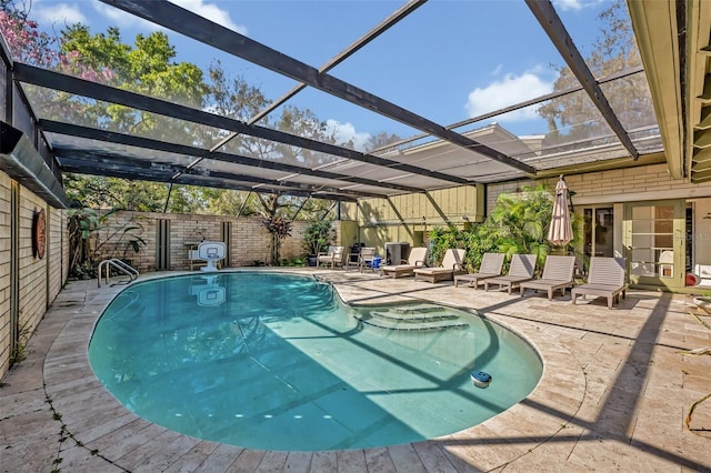 pool with a lanai, a patio area, and a fenced backyard