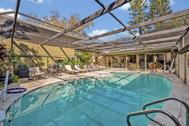 pool with a lanai and a patio area