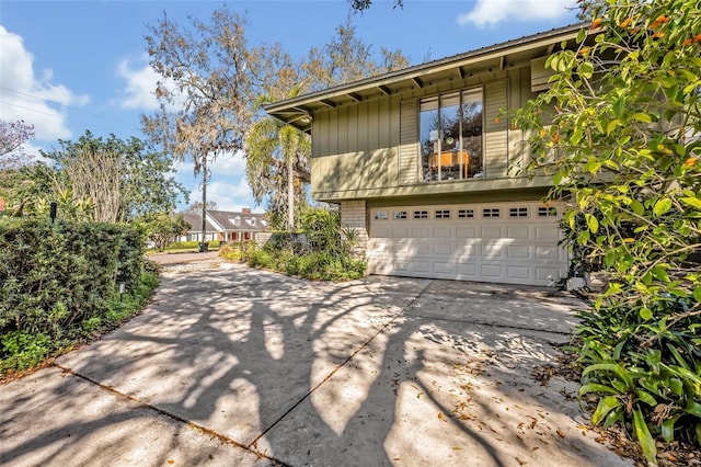 view of property exterior featuring driveway and an attached garage