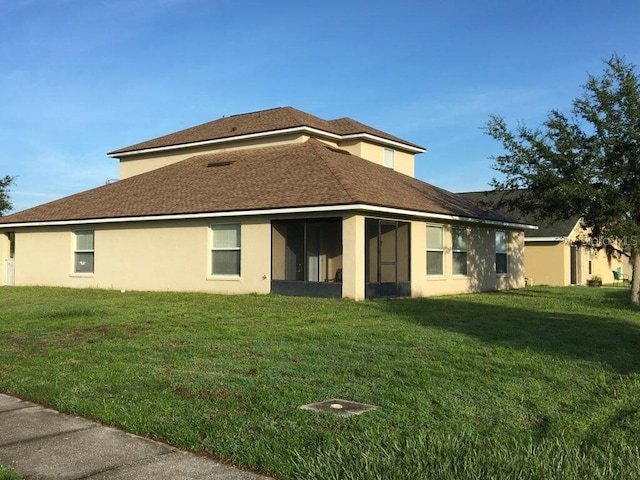 view of property exterior featuring a yard, stucco siding, and a sunroom