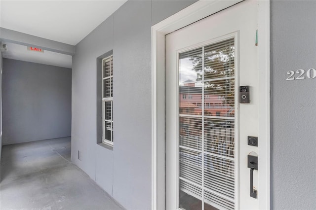 entrance to property featuring stucco siding