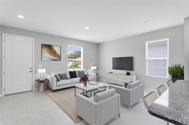 living area featuring light tile patterned floors, baseboards, and recessed lighting