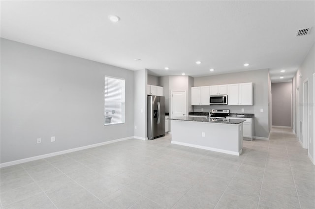 kitchen featuring stainless steel appliances, dark countertops, visible vents, white cabinets, and baseboards