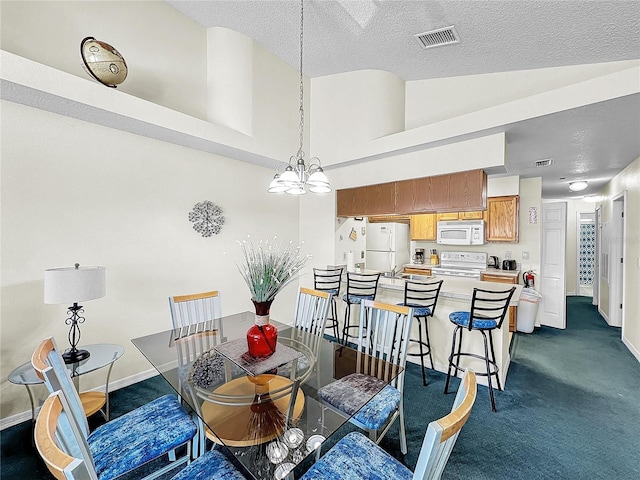 2040 Royal Bay Blvd Unit 30, Kissimmee, FL 34746 - dining room with a textured ceiling, visible vents, baseboards, dark carpet, and an inviting chandelier