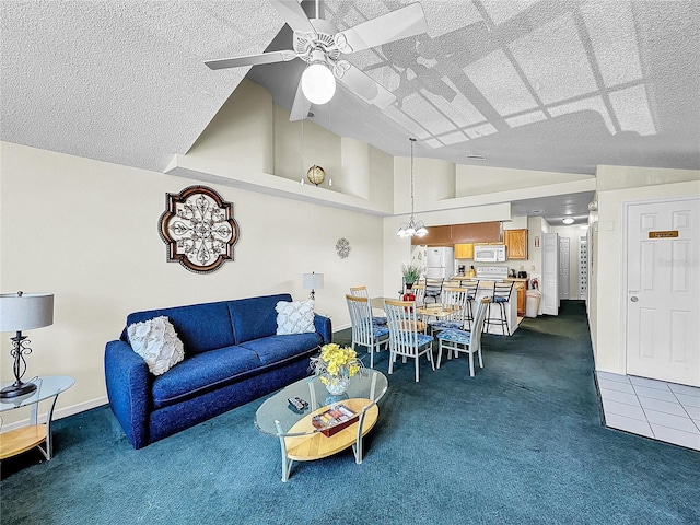 2040 Royal Bay Blvd Unit 30, Kissimmee, FL 34746 - living area featuring baseboards, a ceiling fan, dark colored carpet, a textured ceiling, and high vaulted ceiling