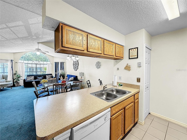 2040 Royal Bay Blvd Unit 30, Kissimmee, FL 34746 - kitchen featuring brown cabinetry, dishwasher, a sink, and a ceiling fan