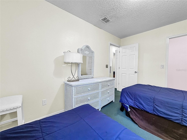 2040 Royal Bay Blvd Unit 30, Kissimmee, FL 34746 - bedroom with visible vents, dark carpet, and a textured ceiling