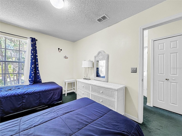 2040 Royal Bay Blvd Unit 30, Kissimmee, FL 34746 - bedroom featuring a textured ceiling, carpet, visible vents, and baseboards
