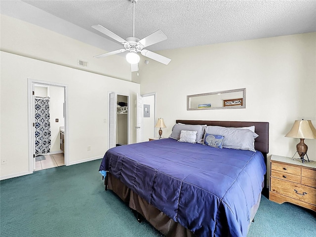 2040 Royal Bay Blvd Unit 30, Kissimmee, FL 34746 - carpeted bedroom with a ceiling fan, vaulted ceiling, a textured ceiling, ensuite bath, and baseboards