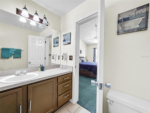 2040 Royal Bay Blvd Unit 30, Kissimmee, FL 34746 - ensuite bathroom featuring visible vents, toilet, ensuite bathroom, a textured ceiling, and vanity