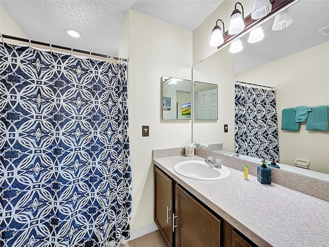 2040 Royal Bay Blvd Unit 30, Kissimmee, FL 34746 - bathroom with a textured ceiling, tile patterned flooring, visible vents, vanity, and a shower with curtain