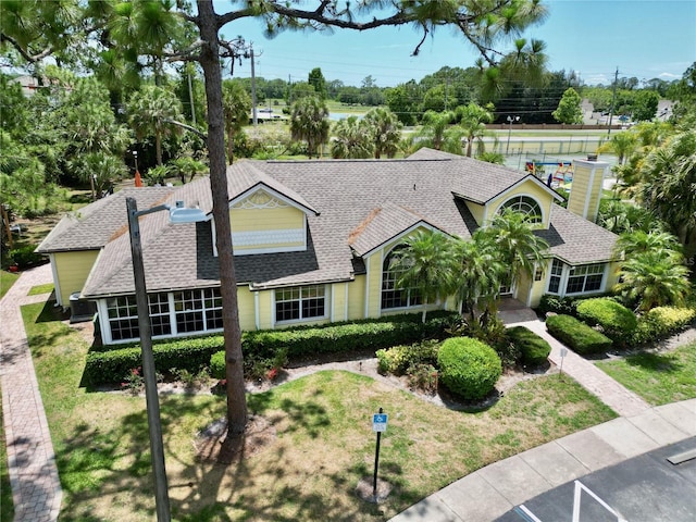 2040 Royal Bay Blvd Unit 30, Kissimmee, FL 34746 - view of front of house featuring a shingled roof and a front lawn