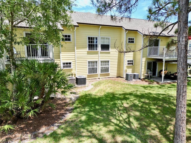 2040 Royal Bay Blvd Unit 30, Kissimmee, FL 34746 - back of house featuring a balcony, a yard, and roof with shingles
