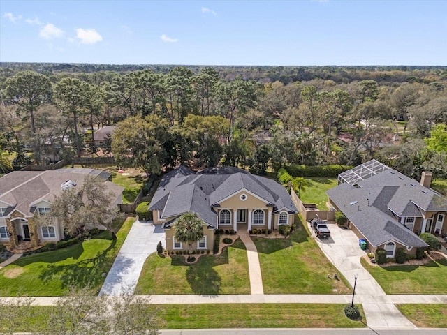 aerial view featuring a residential view and a wooded view