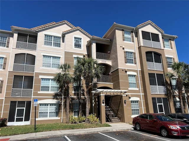 view of building exterior featuring uncovered parking