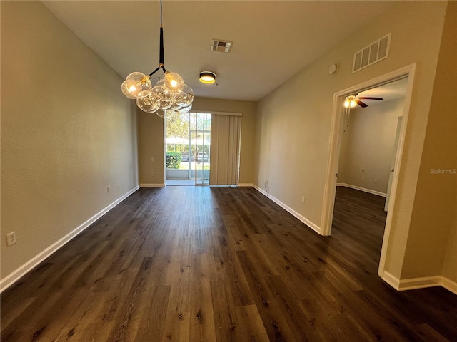 unfurnished dining area featuring baseboards, visible vents, and dark wood-type flooring