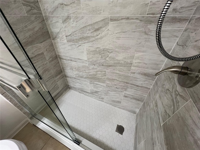 full bath with a tile shower