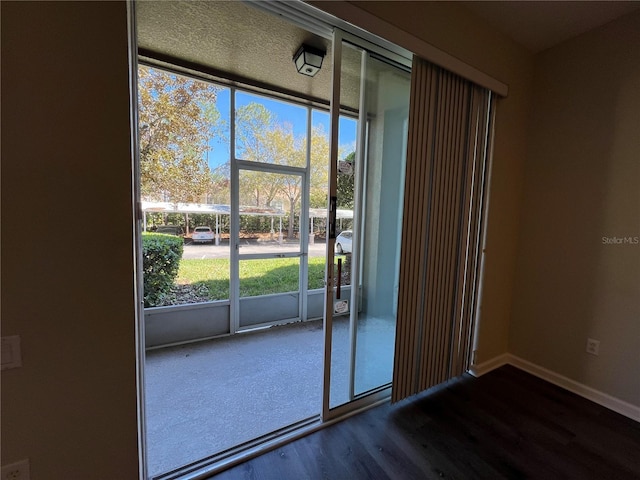 entryway with wood finished floors and baseboards