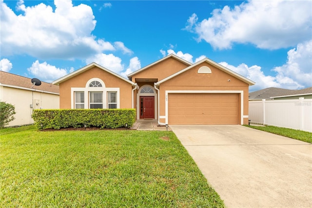 ranch-style home featuring driveway, a garage, fence, a front lawn, and stucco siding