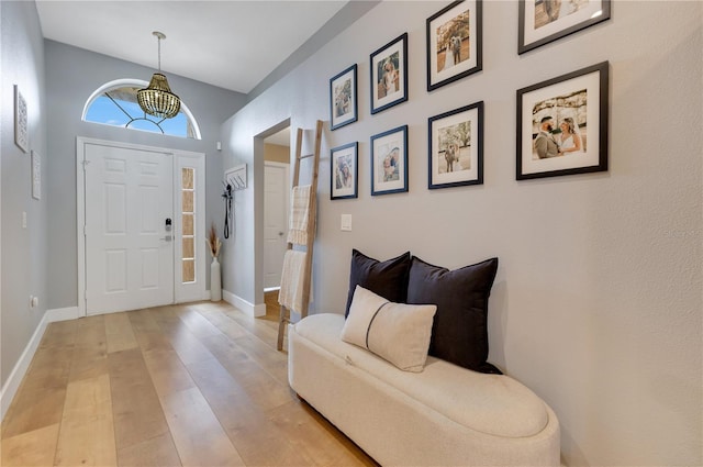 foyer featuring light wood-style flooring and baseboards