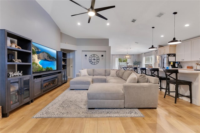 living area featuring ceiling fan, light wood finished floors, visible vents, and recessed lighting